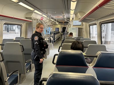 Transit Police officer talking to a passenger on a RTD commuter rail line