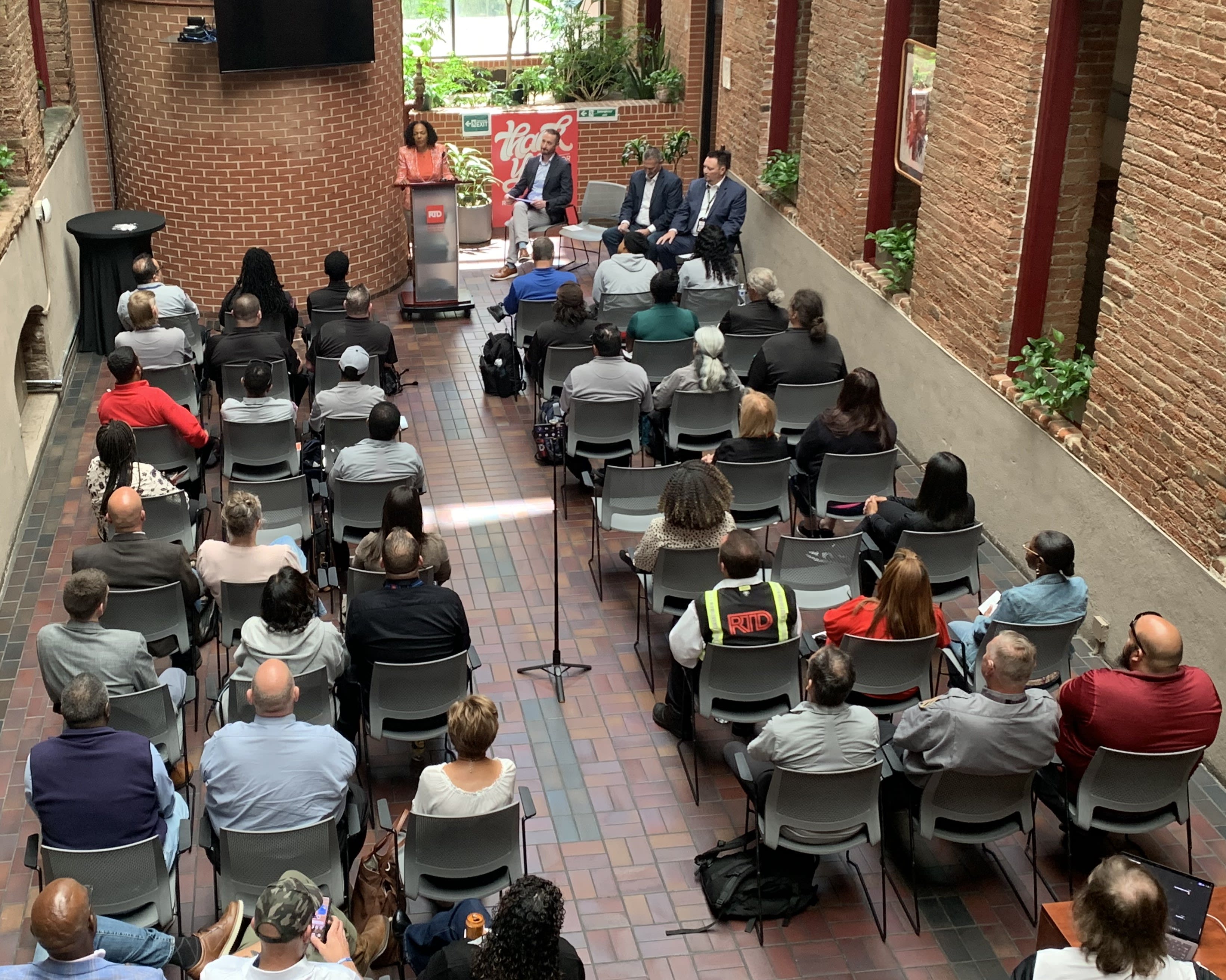 Photo of bus and rail graduates sitting in an audience listening to GM/CEO Johnson