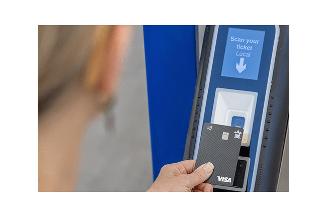 RTD Customer tapping their credit card on a Ticket Validator to pay for fare.
