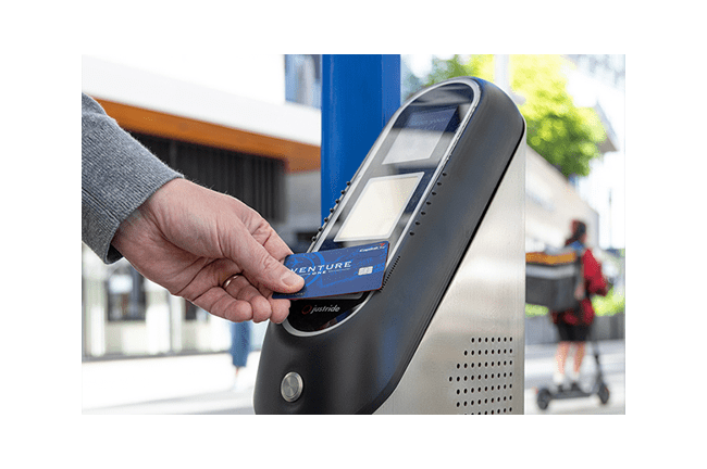 RTD Customer tapping their credit card on a Ticket Validator to pay for fare.