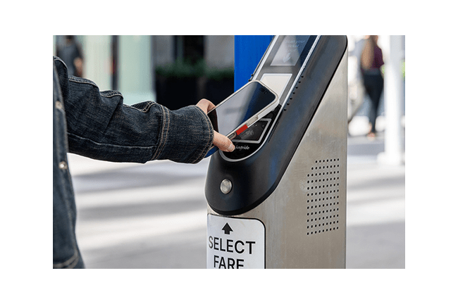 RTD Customer using their mobile device to pay for their fare on a Ticket Validator.