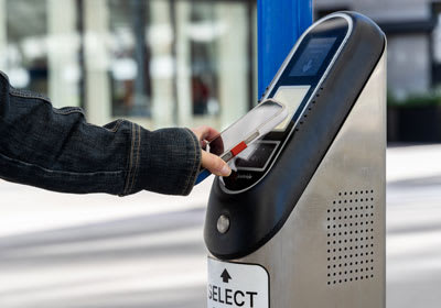 Customer tapping their mobile device on a rail validator