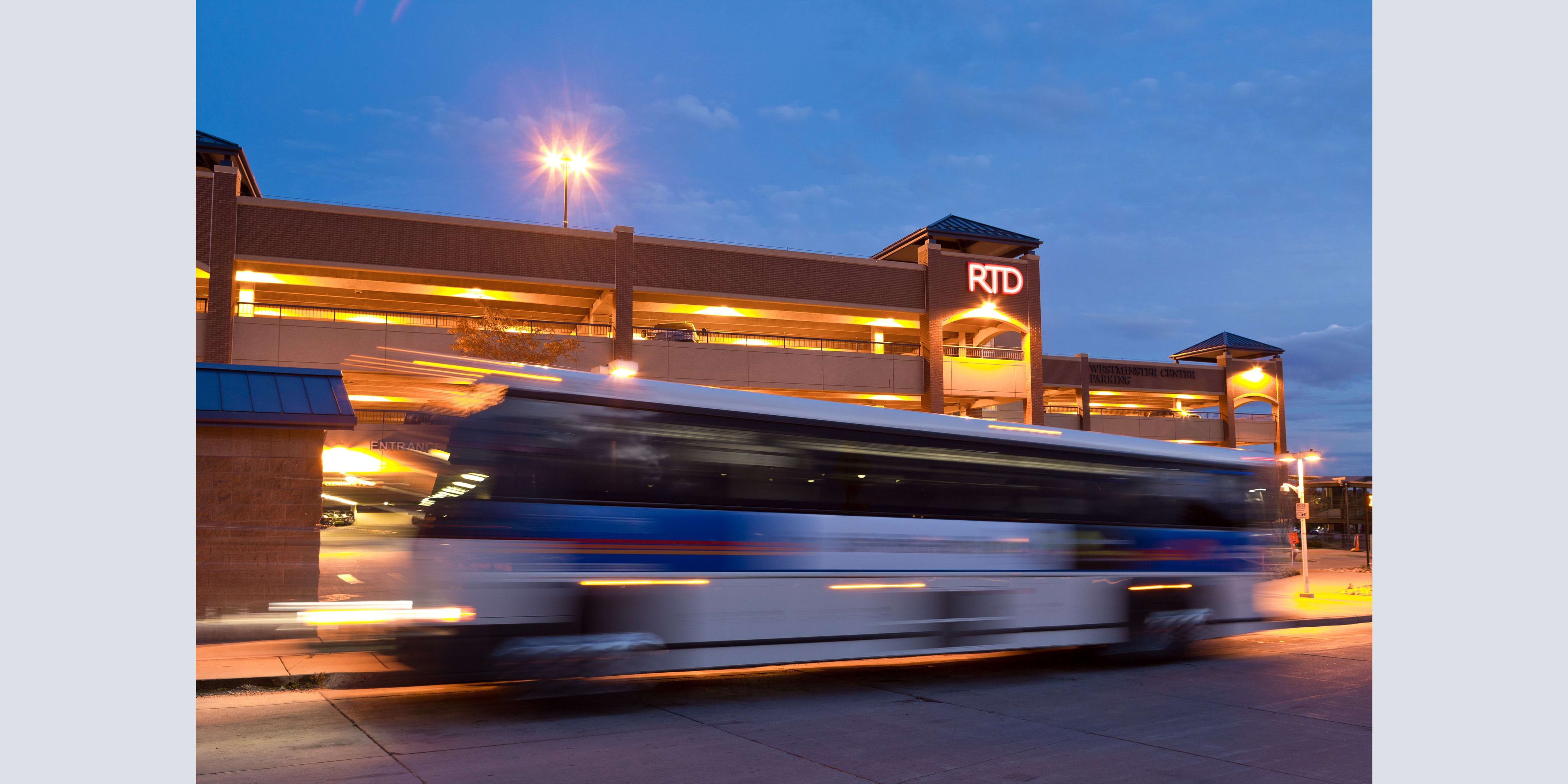 Photo of a bus driving past an RTD parking garage