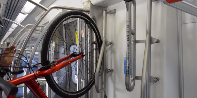 Photo of a bike in a vertical rack on the commuter rail