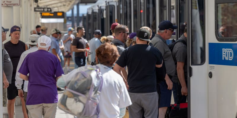 Customers boarding a light rail vehicle