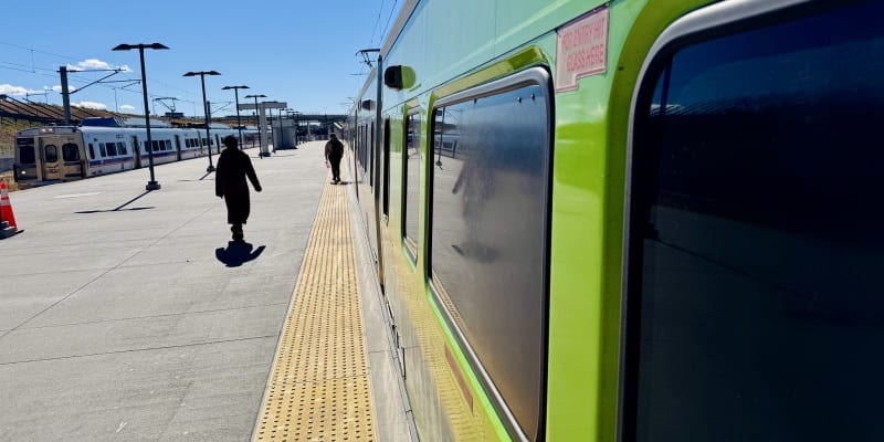 An RTD customer boards an A Line train at the Denver Airport Station on Oct. 28, 2025.