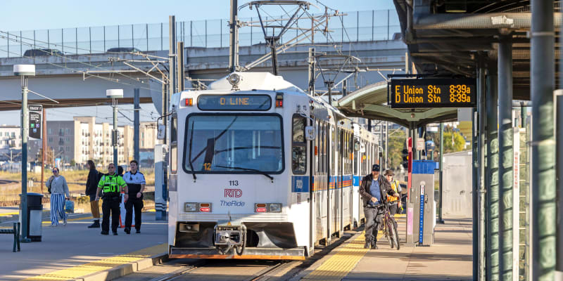 Light rail train at RTD's I-25 and Broadway Station with customers boarding the vehicle