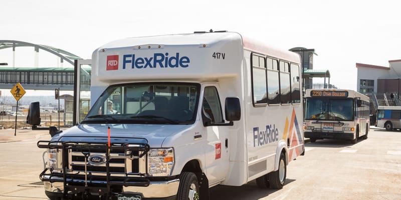 A FlexRide vehicle awaits customers at a station.