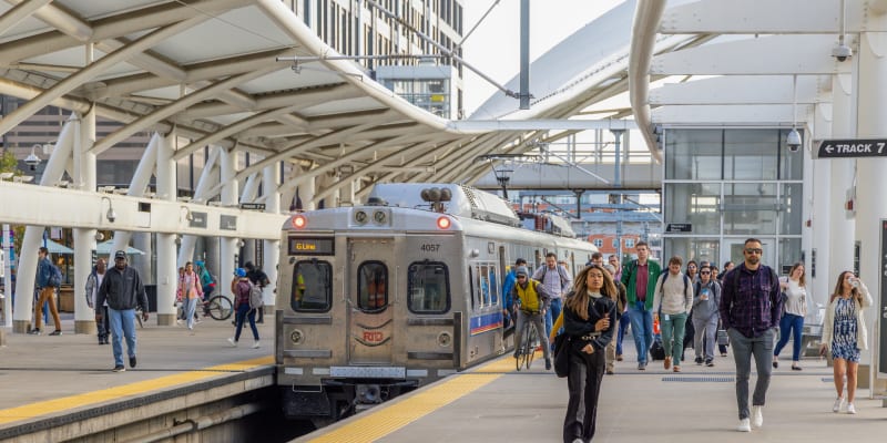 Customers at Denver Union Station near RTD's G Line commuter rail train