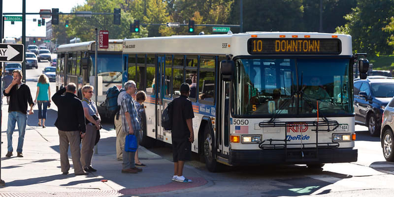 Customers board a Route 10 bus to downtown Denver