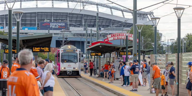 A photo of Broncos fans waiting to board a light rail train at Empower Field at Mile High Stadium