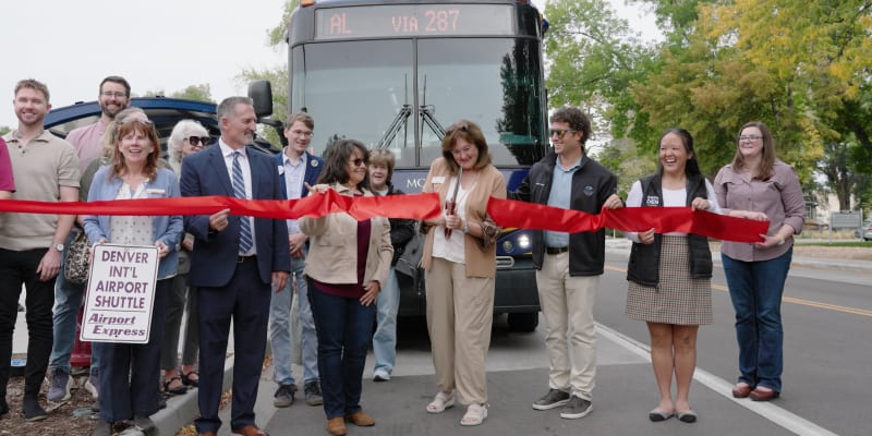 A photo of RTD and Longmont officials cutting a ribbon to launch Route AL service