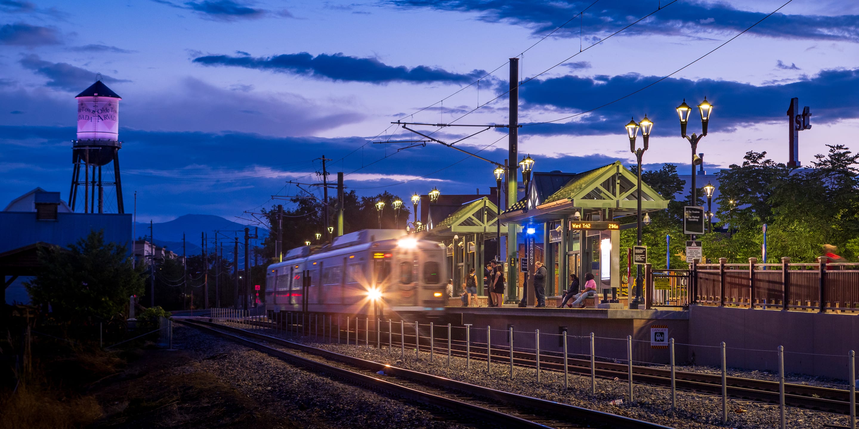 Arvada Station at night with the commuter rail in the background