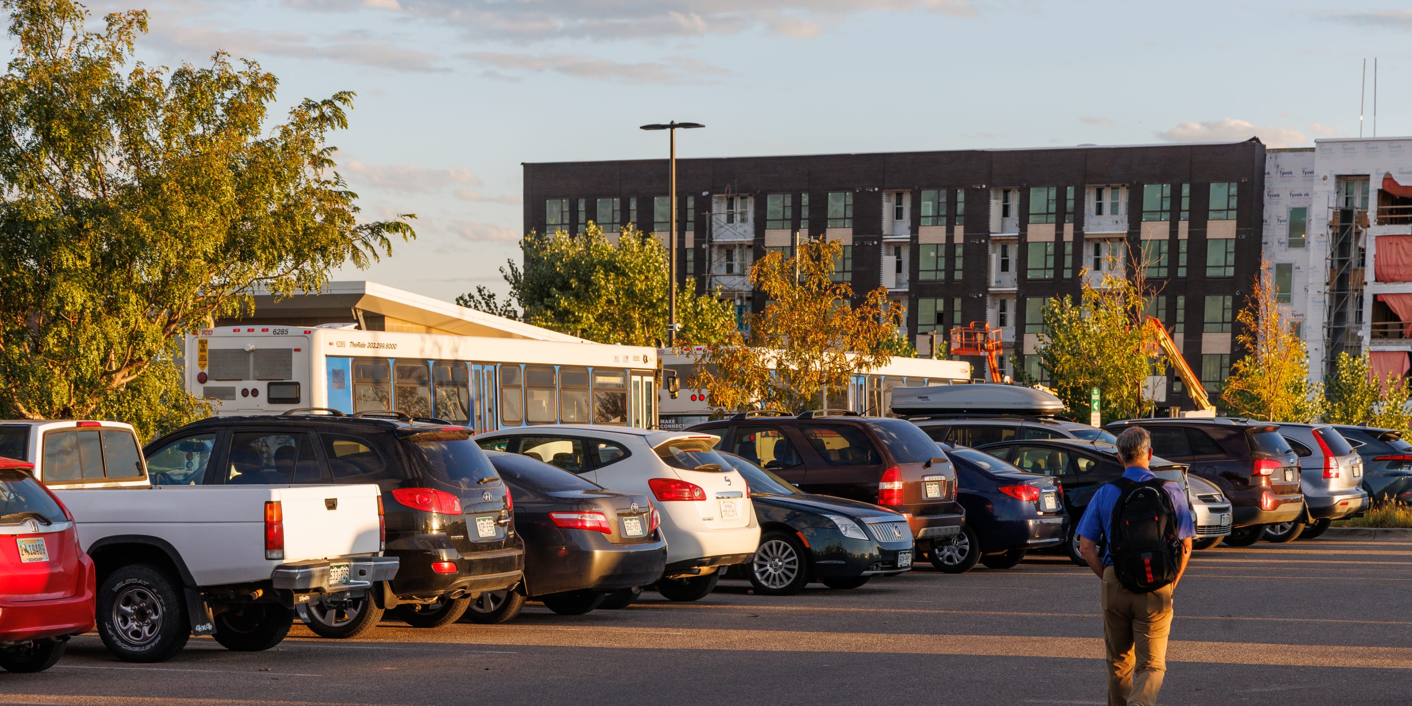 Cars parked in a parking lot at a bus station
