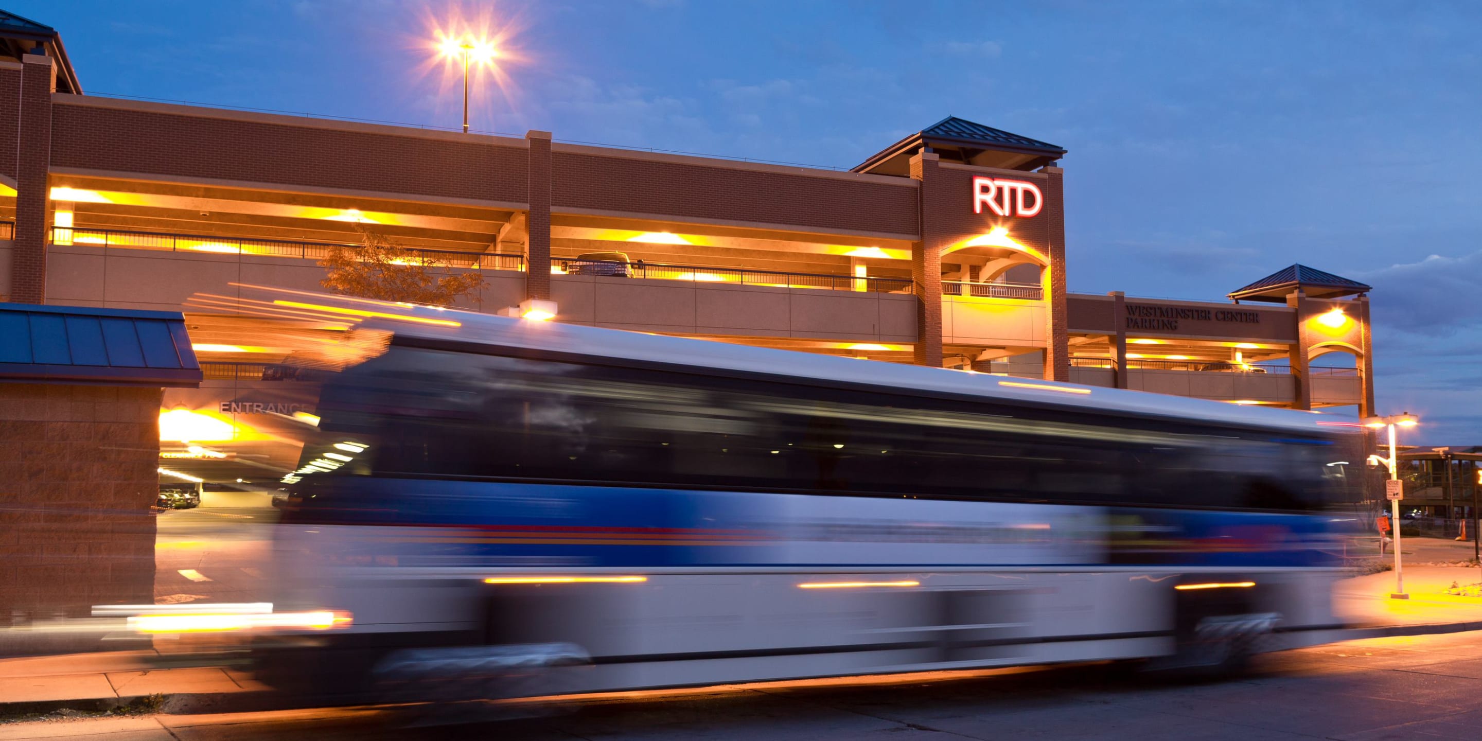 Photo of a bus driving past an RTD parking garage