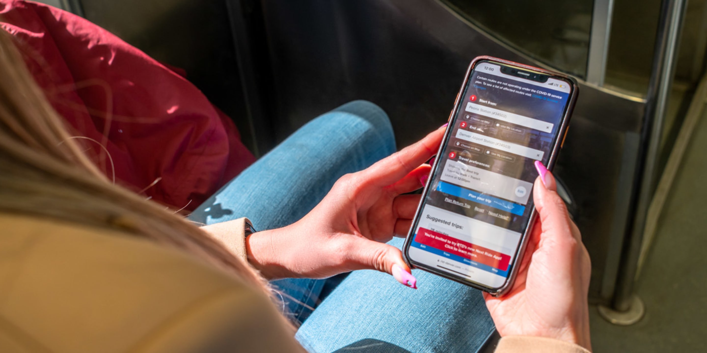 Customer looking at their phone with myride app on screen