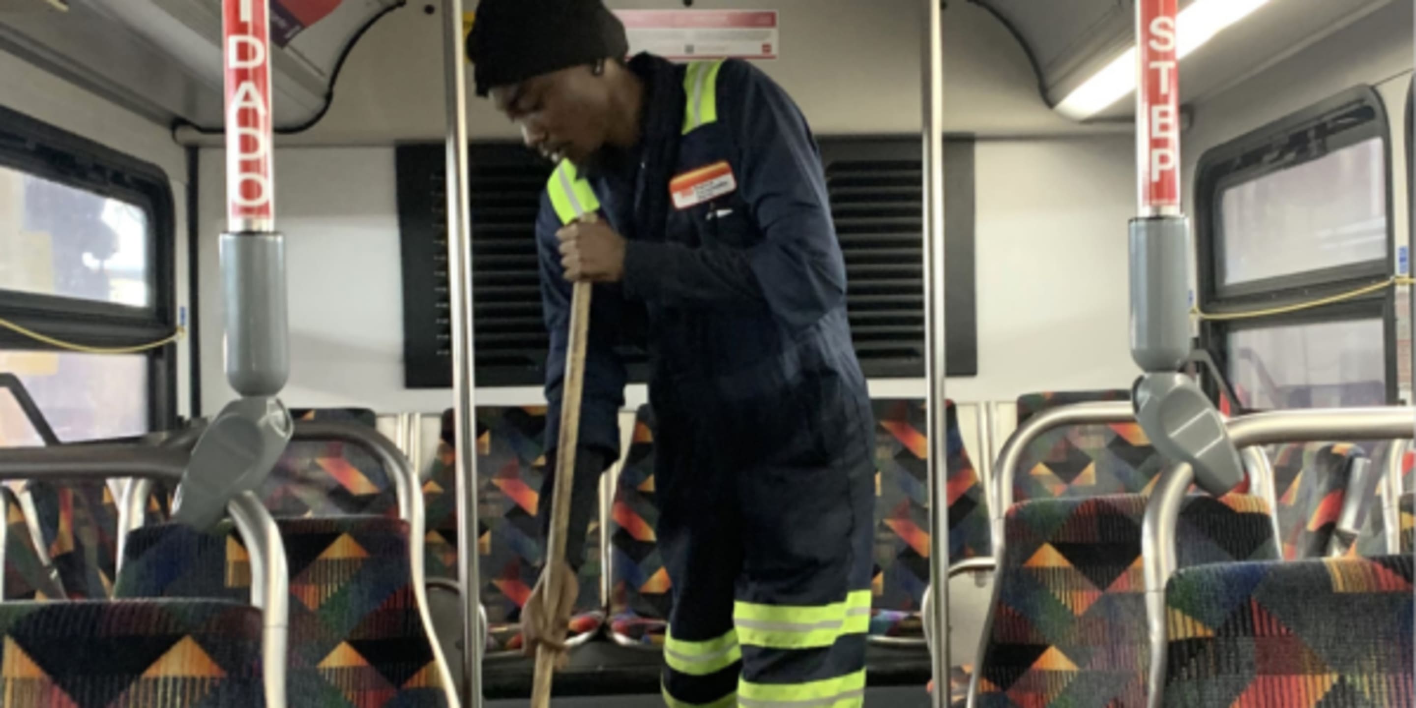 Staff person sweeping bus
