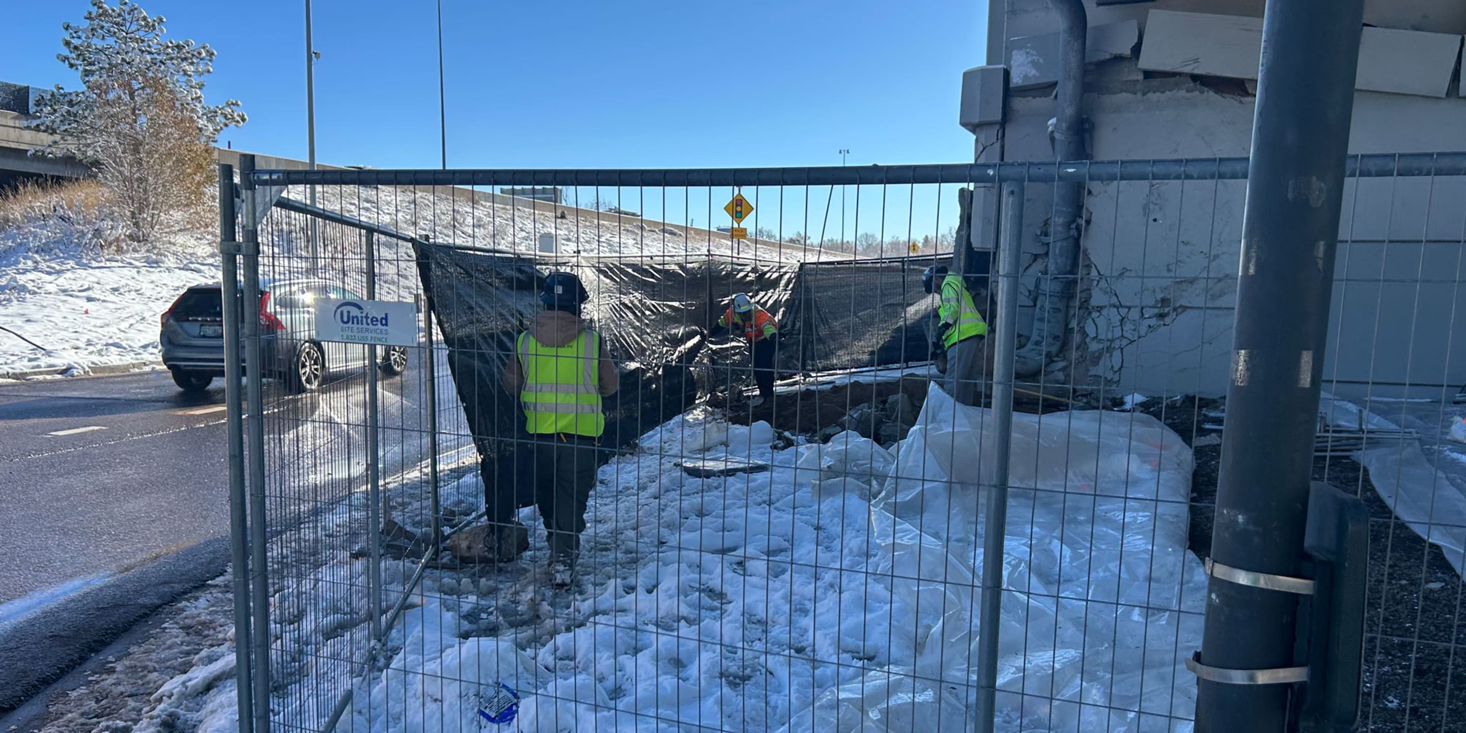 Crews constructing temporary fence around the crash site at the Yale Street bridge
