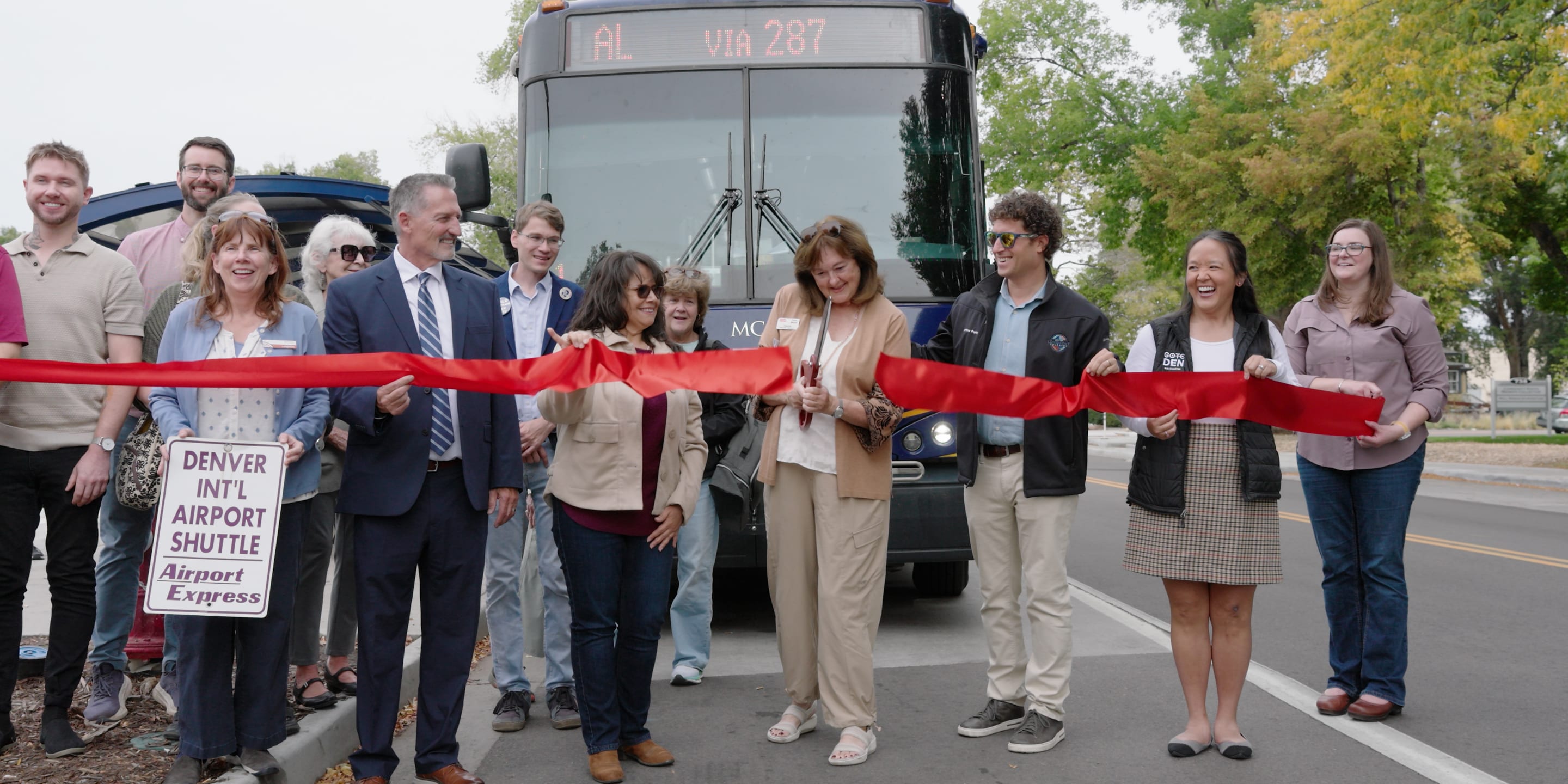 A photo of RTD and Longmont officials cutting a ribbon to launch Route AL service