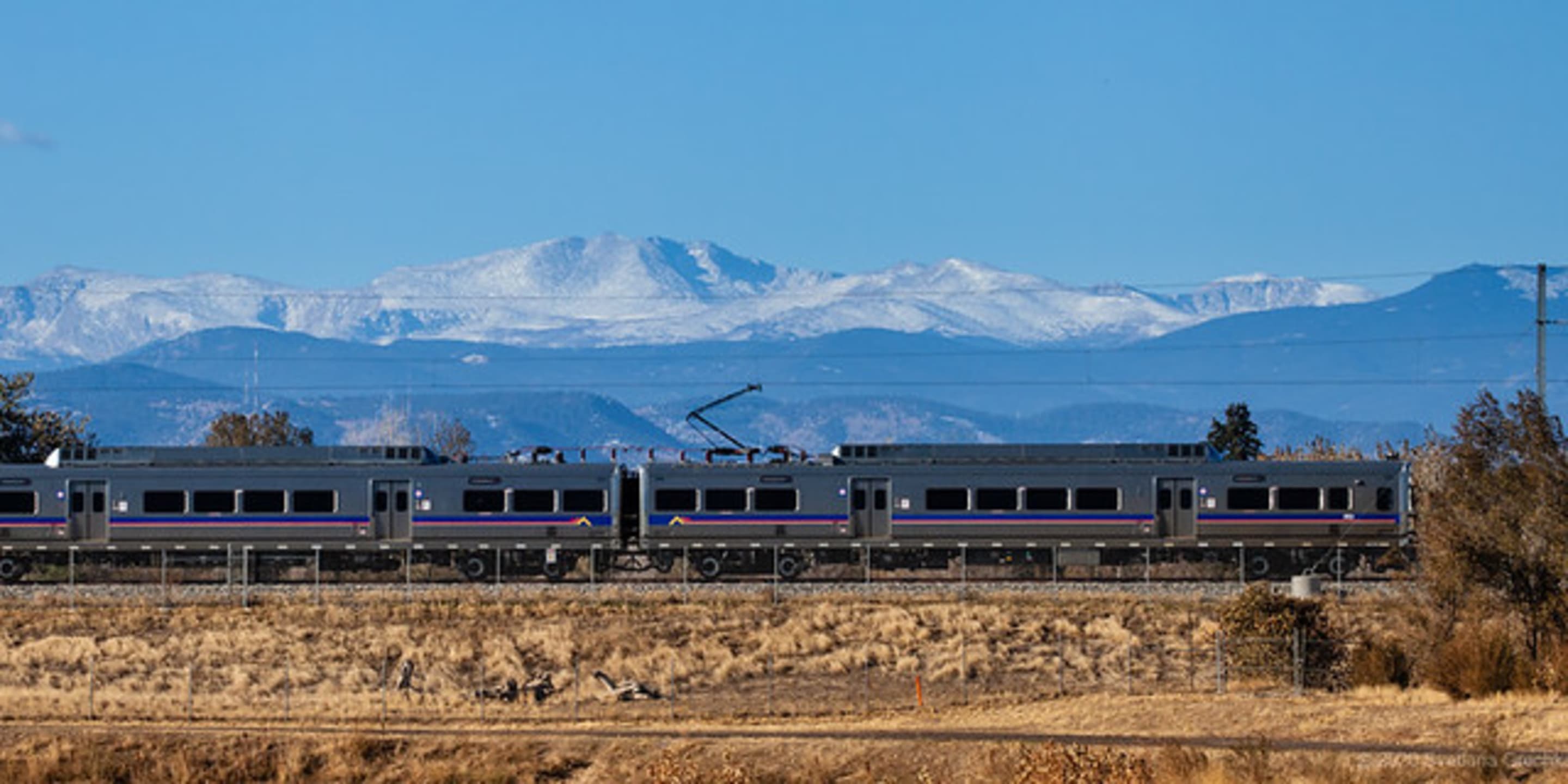 A photo of an N Line train with mountains in the background