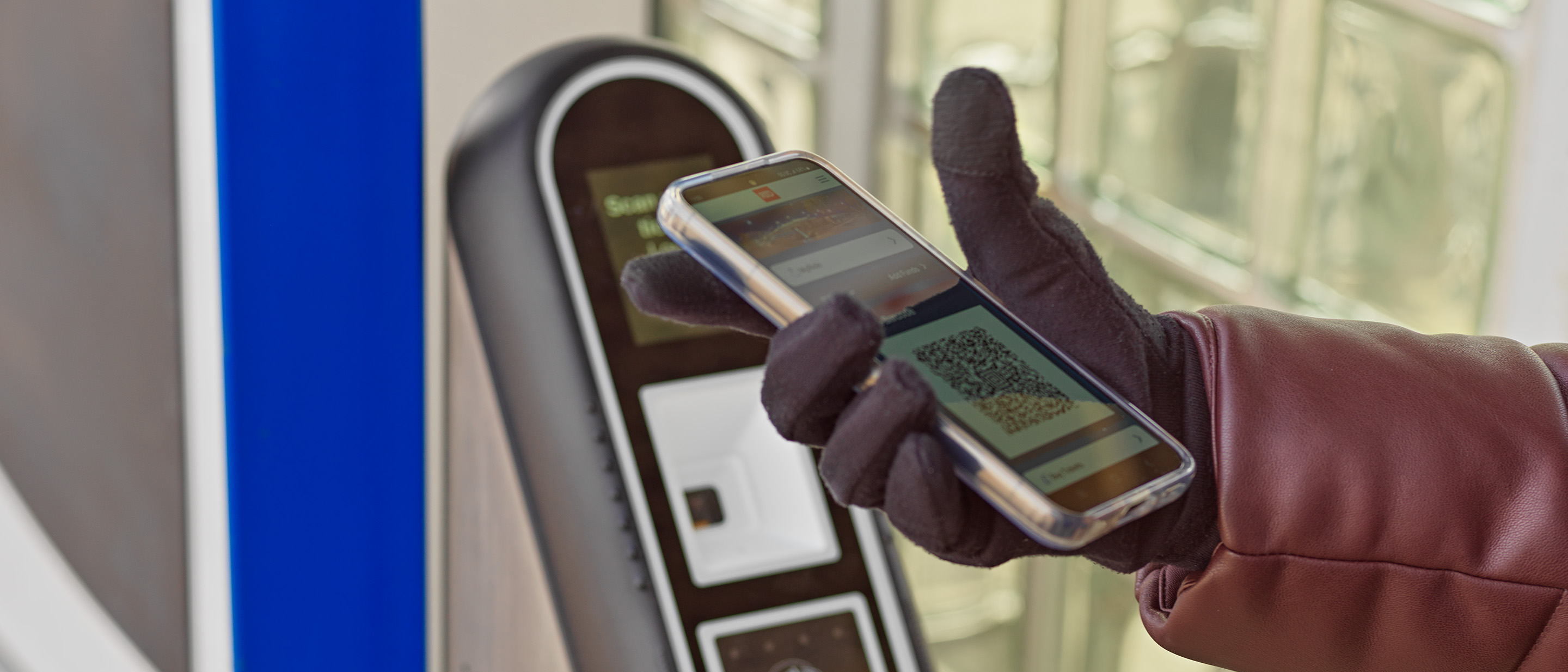 Photo of a customer scanning their MyRide barcode at a ticket validator