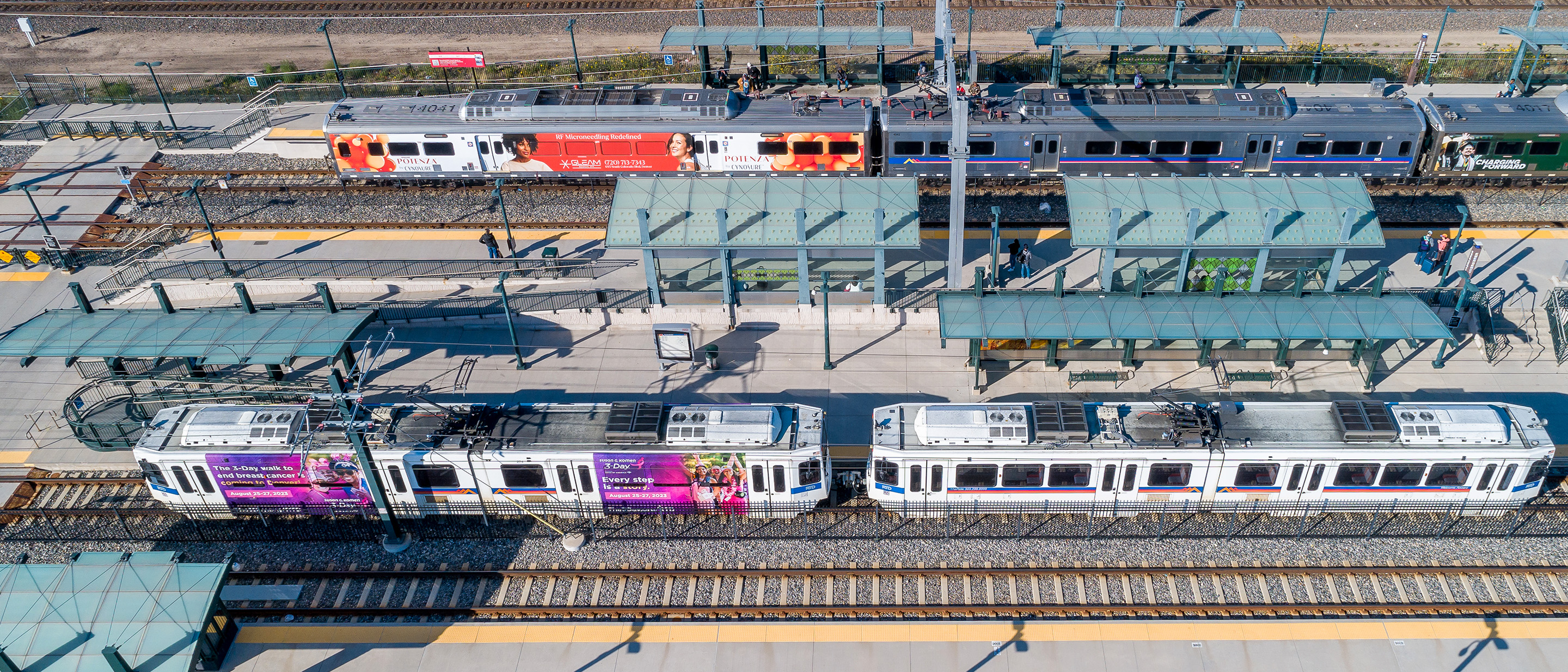 Drone photo showing a commuter rail line and light rail at train station