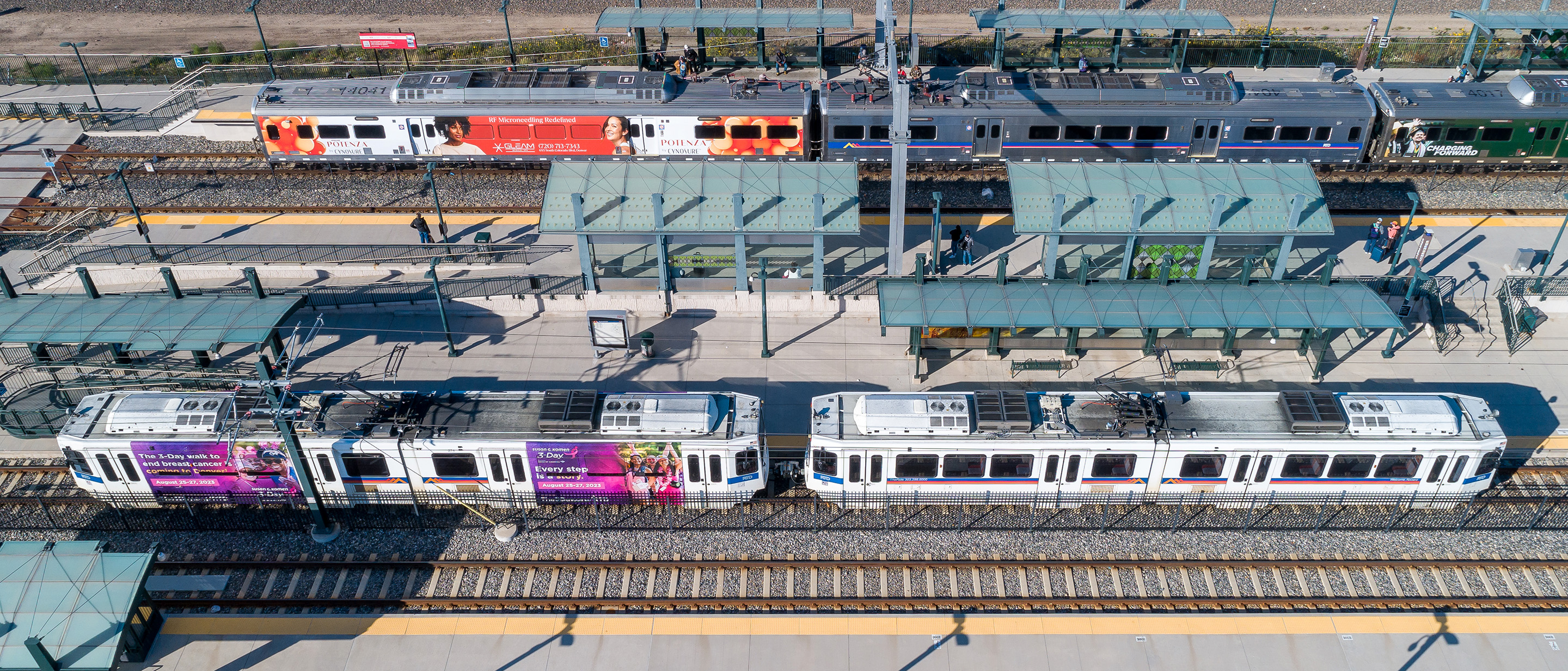 Drone photo showing a commuter rail line and light rail at train station