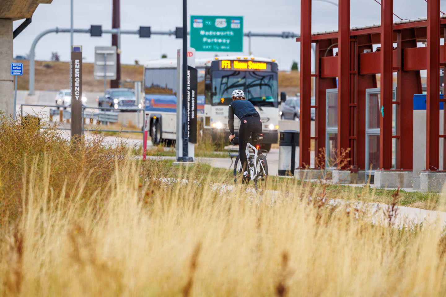 Person riding a bike passing a FlatIron Flyer bus stop