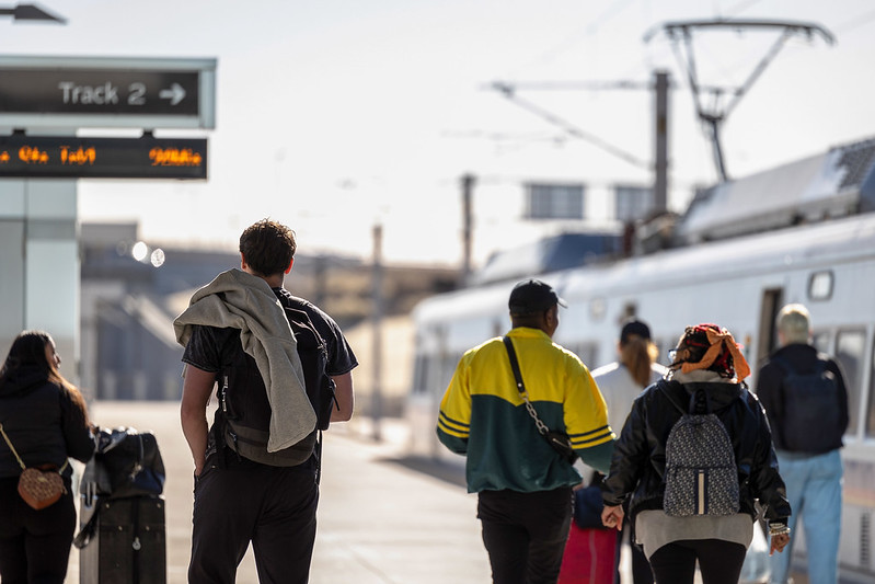 Customers walking next to an A Line train