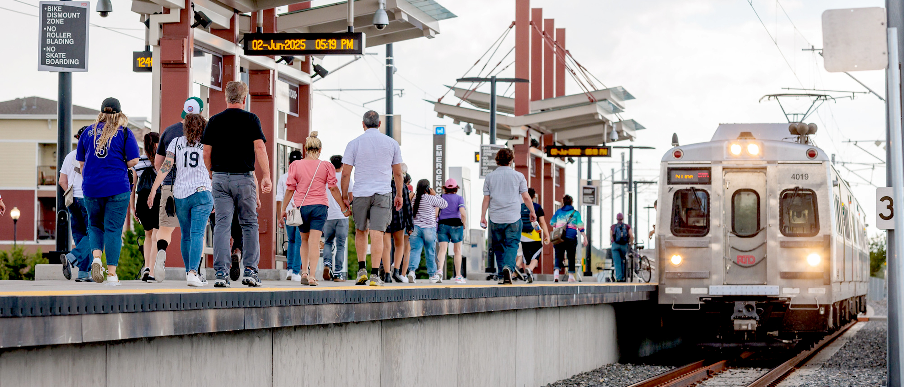 Customers on a commuter rail platform waiting for a train